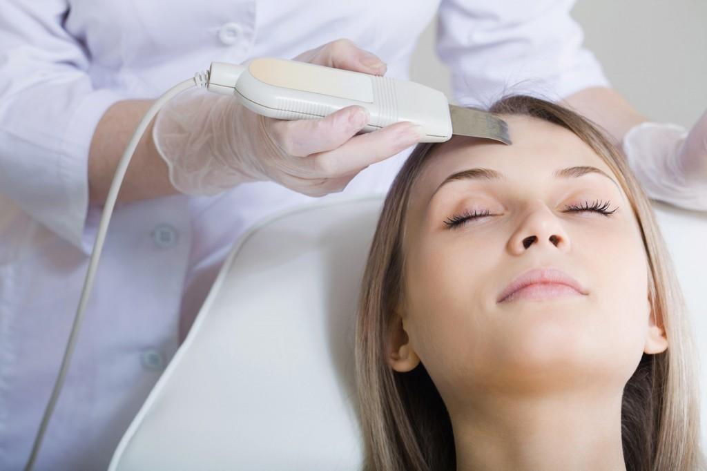 Woman lies on a table in a beauty spa getting a treatment