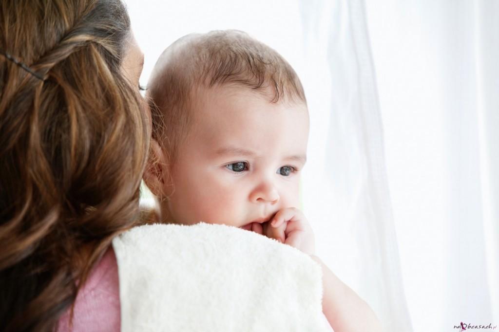 Portrait of a mother pampering her baby after the bath at home