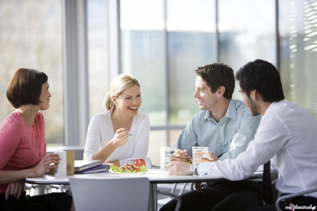 Four Office Colleagues Eating Lunch in Office Canteen or Cafe