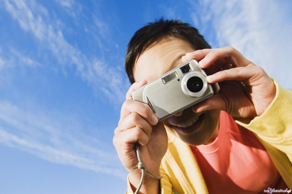 Portrait of man taking picture with camera