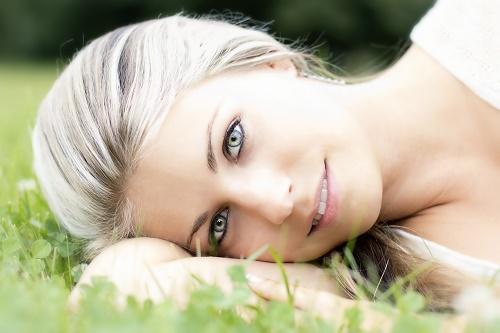 Beautiful sexy woman relaxing on the grass