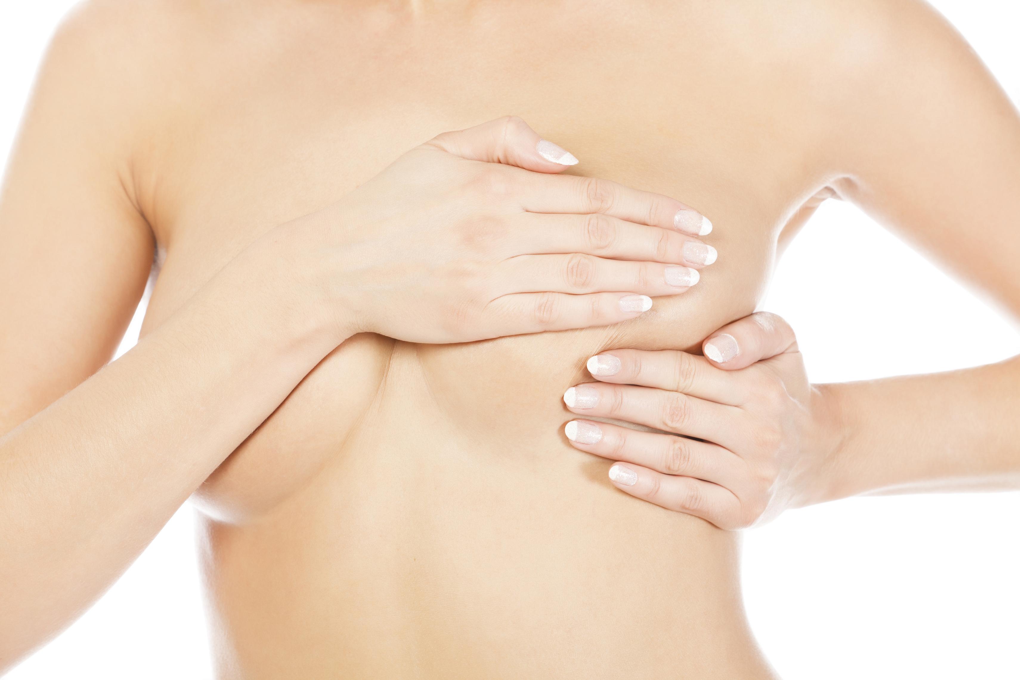 Breast cancer, woman holding her breast