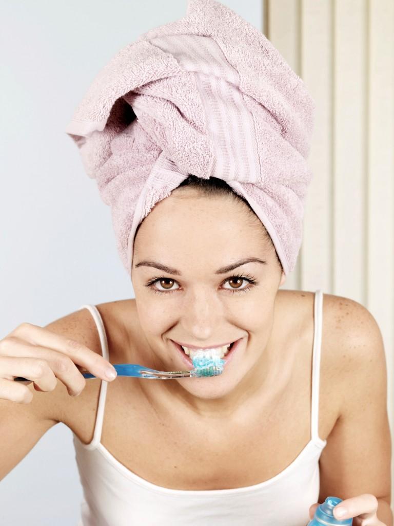 Young Woman Brushing Teeth. Model Released