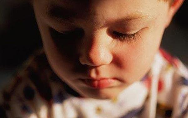 A mournful shot of a young boy.