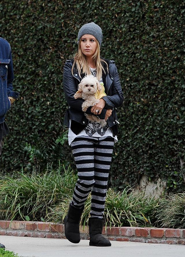 Ashley Tisdale and her husband Christopher French wear matching skeleton t-shirts on a walk with their pet dog