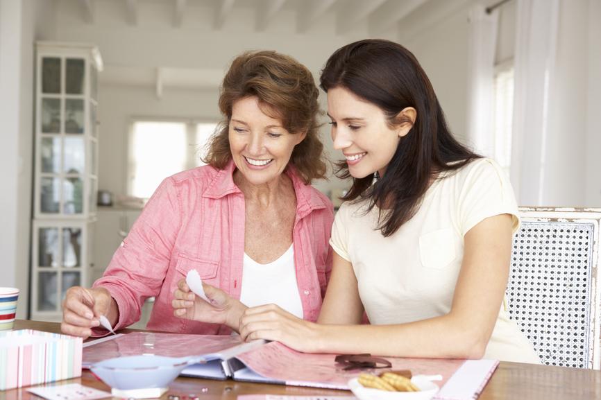 Adult mother and daughter scrapbooking