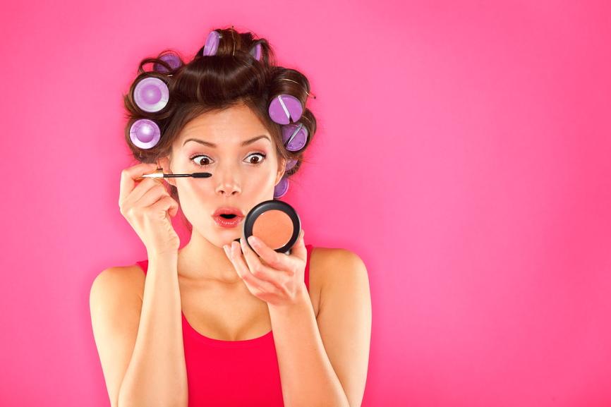 Makeup mascara woman with hair rollers