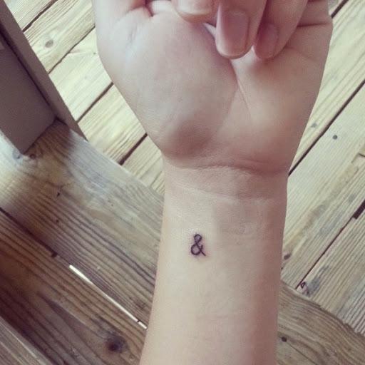 & music symbol small tattoo on wrist