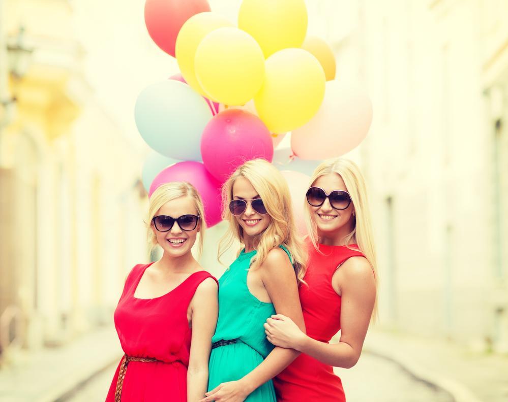 beautiful girls with colorful balloons in the city