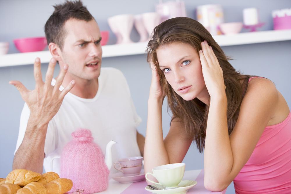 A young couple arguing at the breakfast table