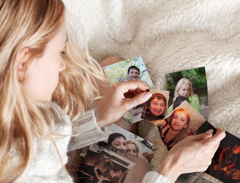 Young woman, tearing photo