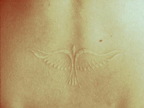 flying-bird-white-ink-tattoo-design-for-women