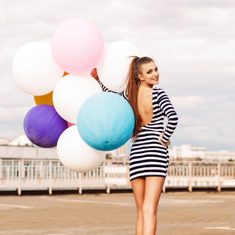 beautiful lady in short black and white striped dress holds bunc