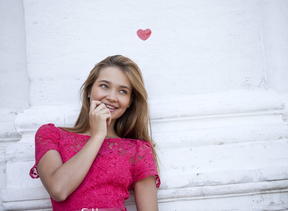 Portrait of love woman in love and a symbol of love - red heart