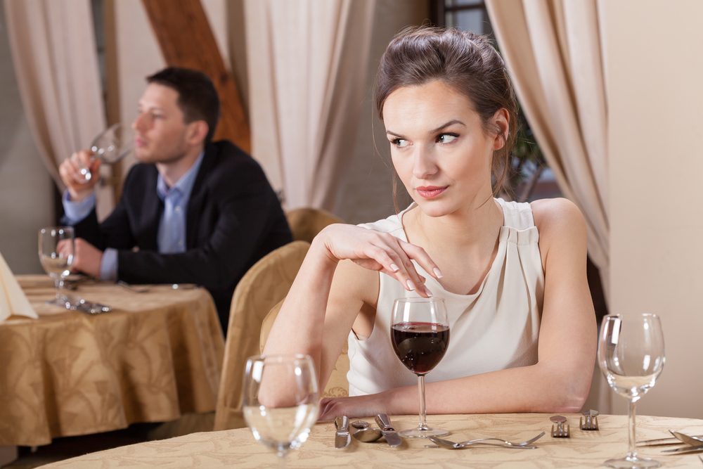 Single woman drinking wine in a restaurant