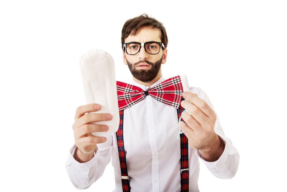 Handsome man wearing suspenders with menstruation pad.