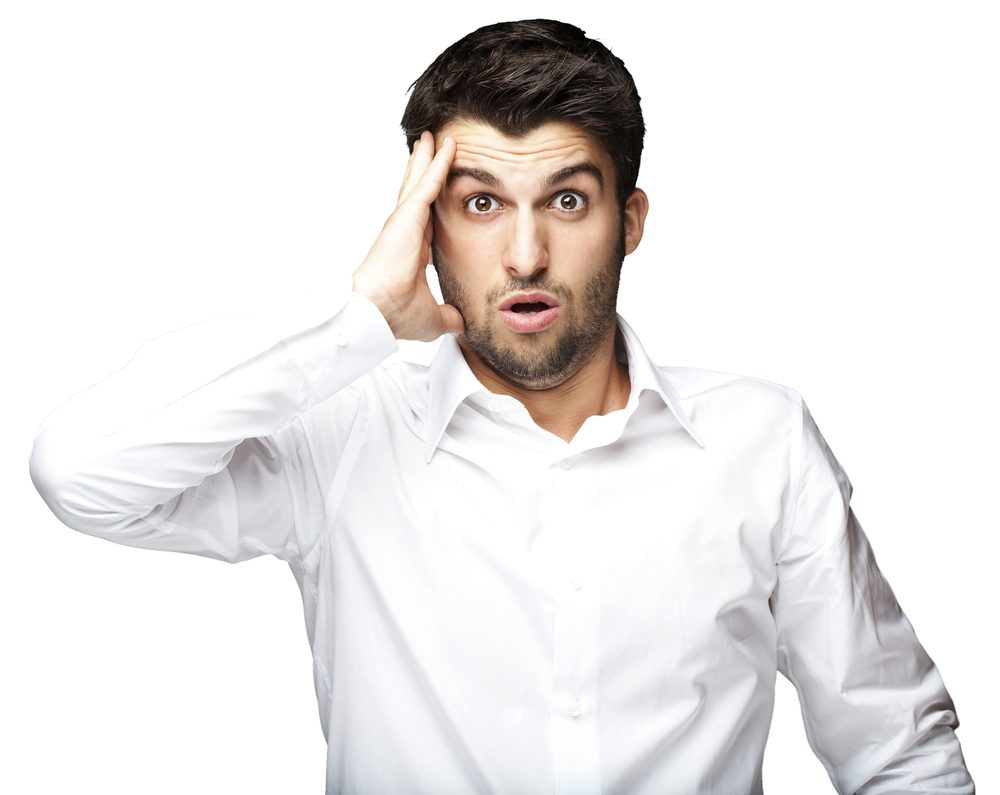 portrait of young man surprised against a white background