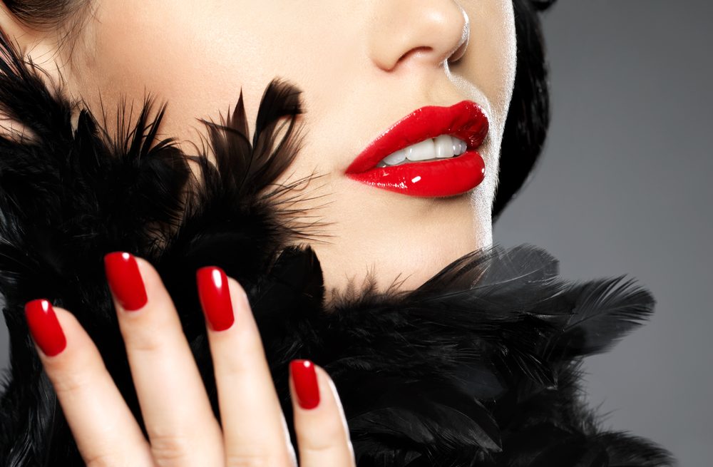 Macro photo of  woman with fashion red nails and sensual lips