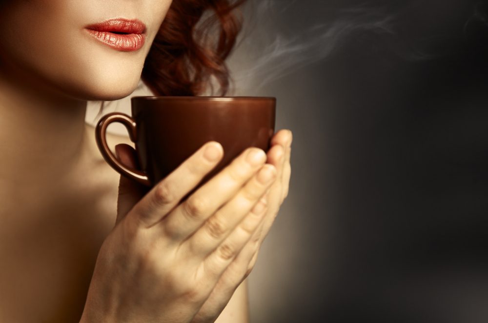 Beautiful Woman Drinking Coffee. Space for text