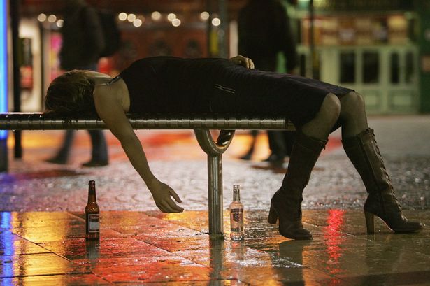 A woman lies on a bench after leaving a bar in Bristol City Centre