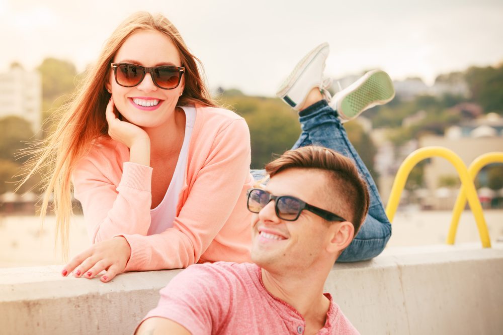 Smiling, cheerful and positive. Portrait of young happy couple dating outdoor at sea.