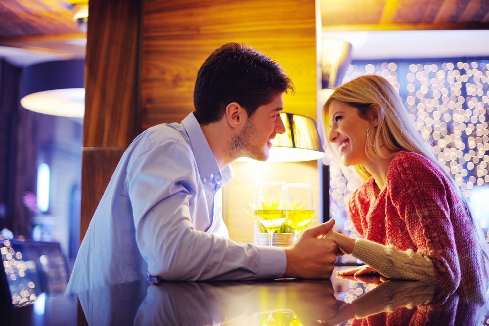 romantic evening date in restaurant happy young couple with wine glass tea and cake