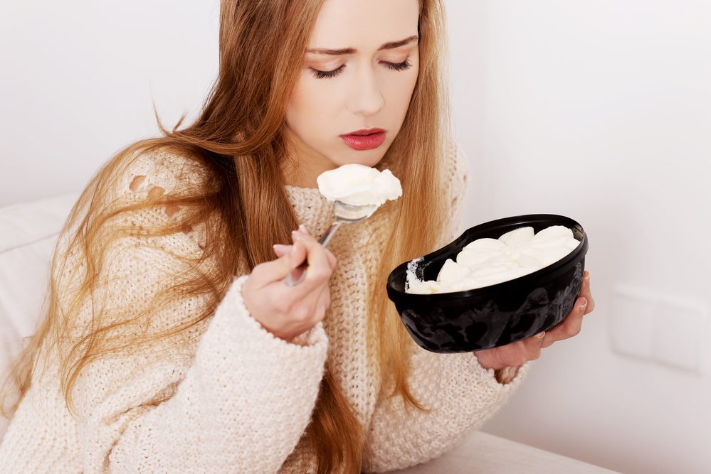 Woman eating ice cream for a better humor