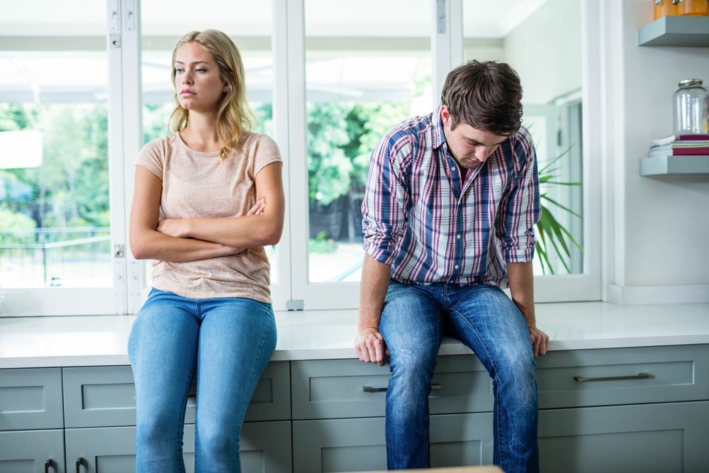 Annoyed couple ignoring each other in the kitchen