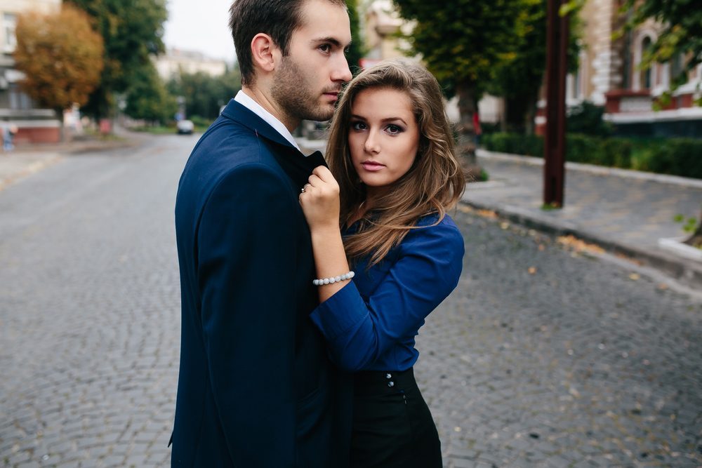 man and woman arguing on a city street