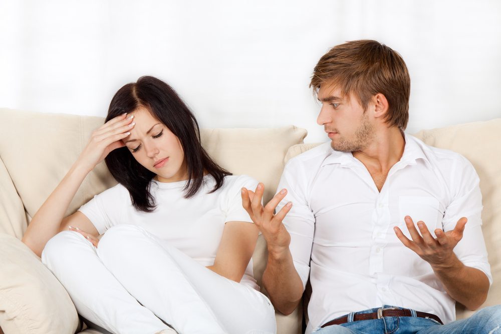 Beautiful young couple sitting on a sofa