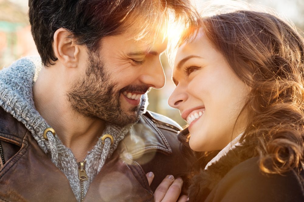 Portrait of happy young couple looking at each other and smiling outdoor