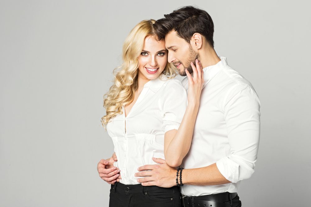 Portrait of blond smiling woman with white teeth and handsome man