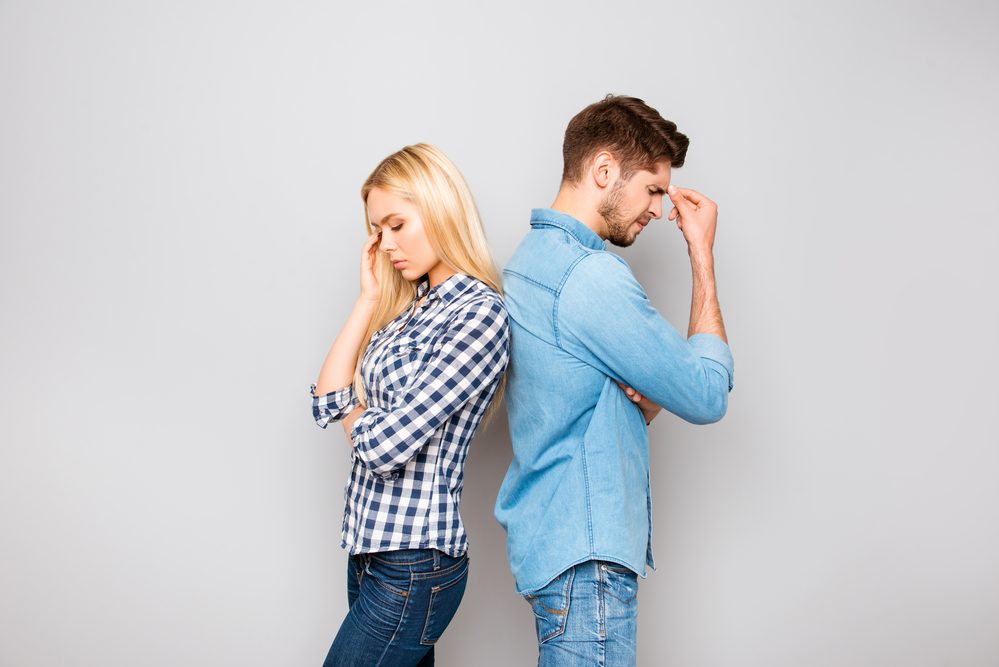 Portrait of sad man and woman with headache after quarrel