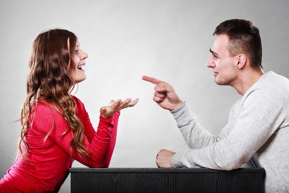 Happy couple talking and laughing on date. Smiling girl and guy having conversation. Amusing man making woman laugh. Good relationship.